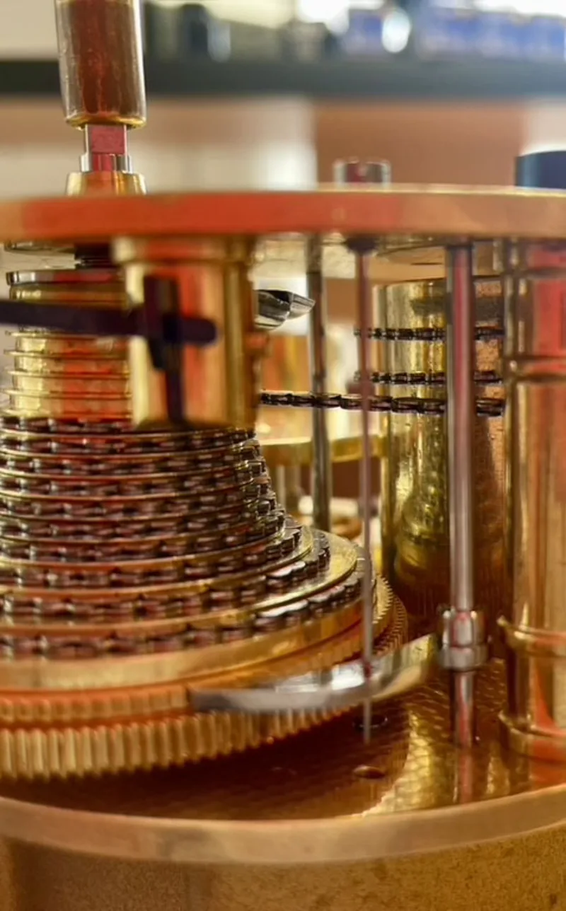 Close-up of a historic clock movement with brass, wheels and pinions